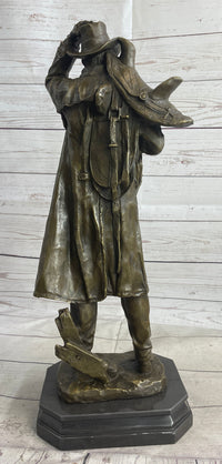 Country Western Cowboy Hauling Saddle Bronze Sculpture