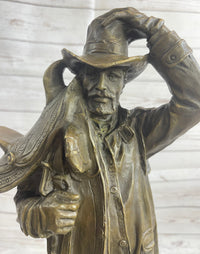 Country Western Cowboy Hauling Saddle Bronze Sculpture