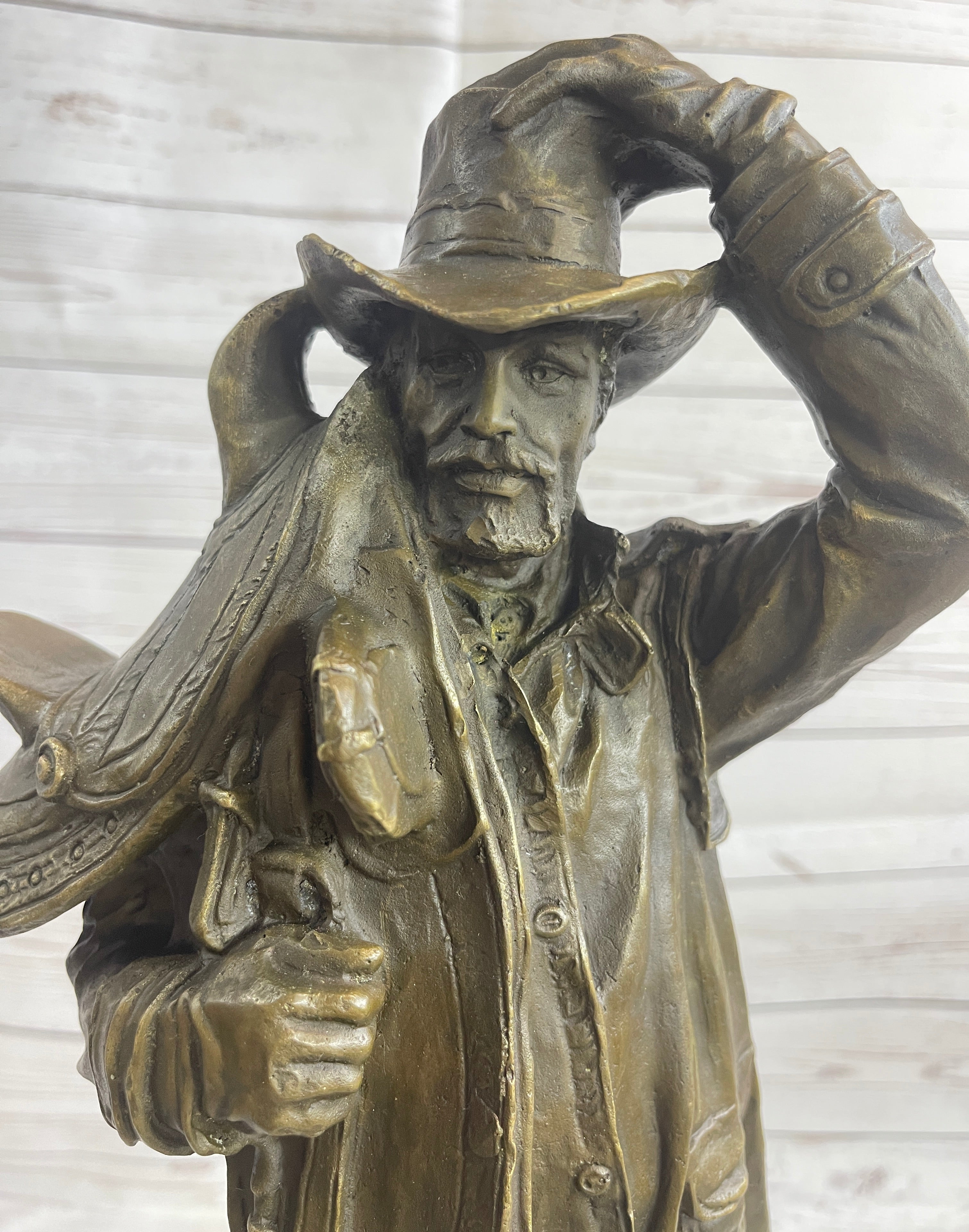 Country Western Cowboy Hauling Saddle Bronze Sculpture