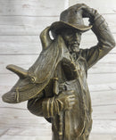 Country Western Cowboy Hauling Saddle Bronze Sculpture