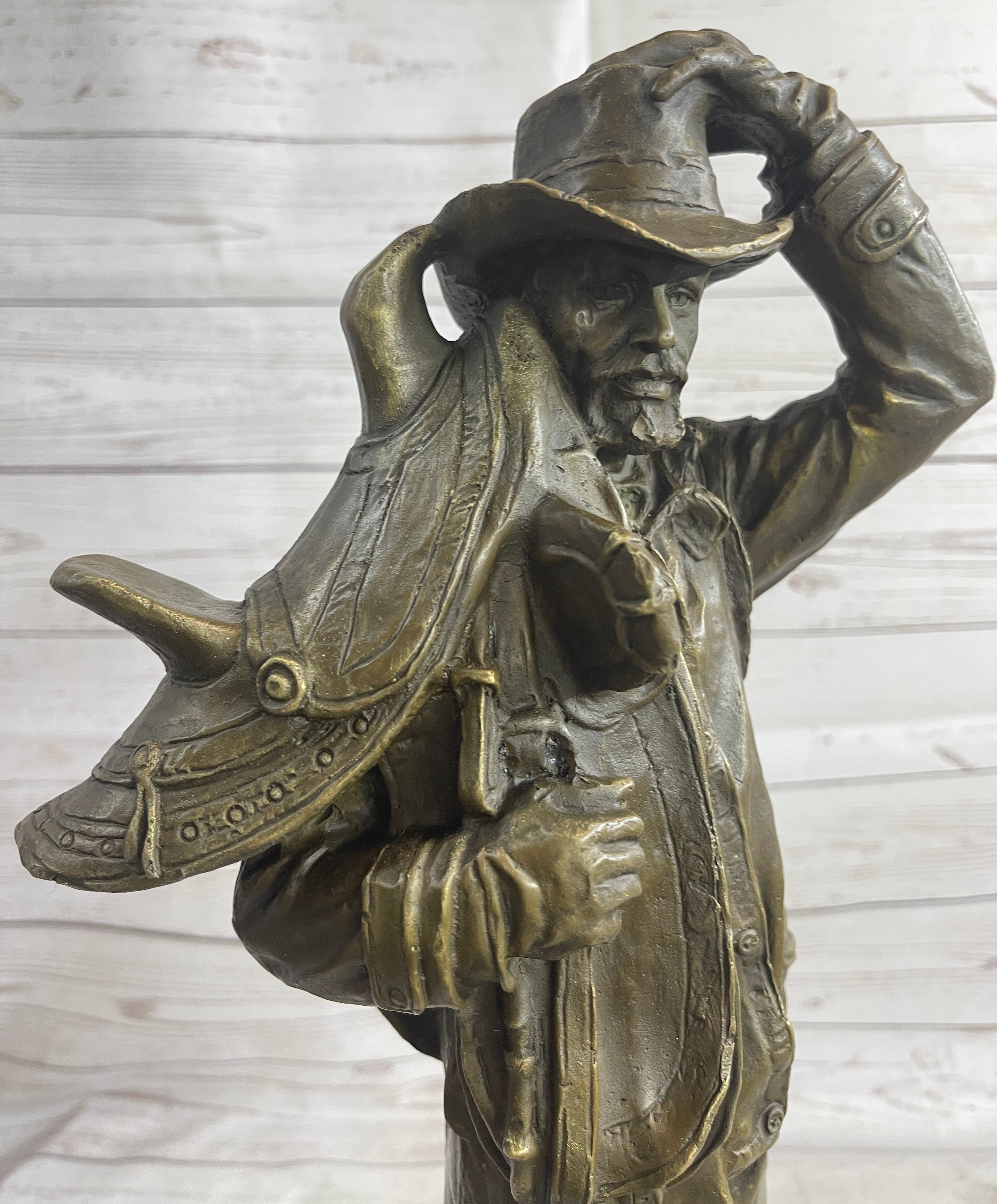 Country Western Cowboy Hauling Saddle Bronze Sculpture
