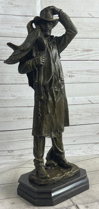 Country Western Cowboy Hauling Saddle Bronze Sculpture
