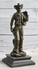 Cowboy in Chaps Carrying Horse Saddle Bronze 12" x 4"