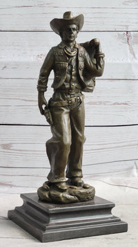 Cowboy in Chaps Carrying Horse Saddle Bronze 12" x 4"