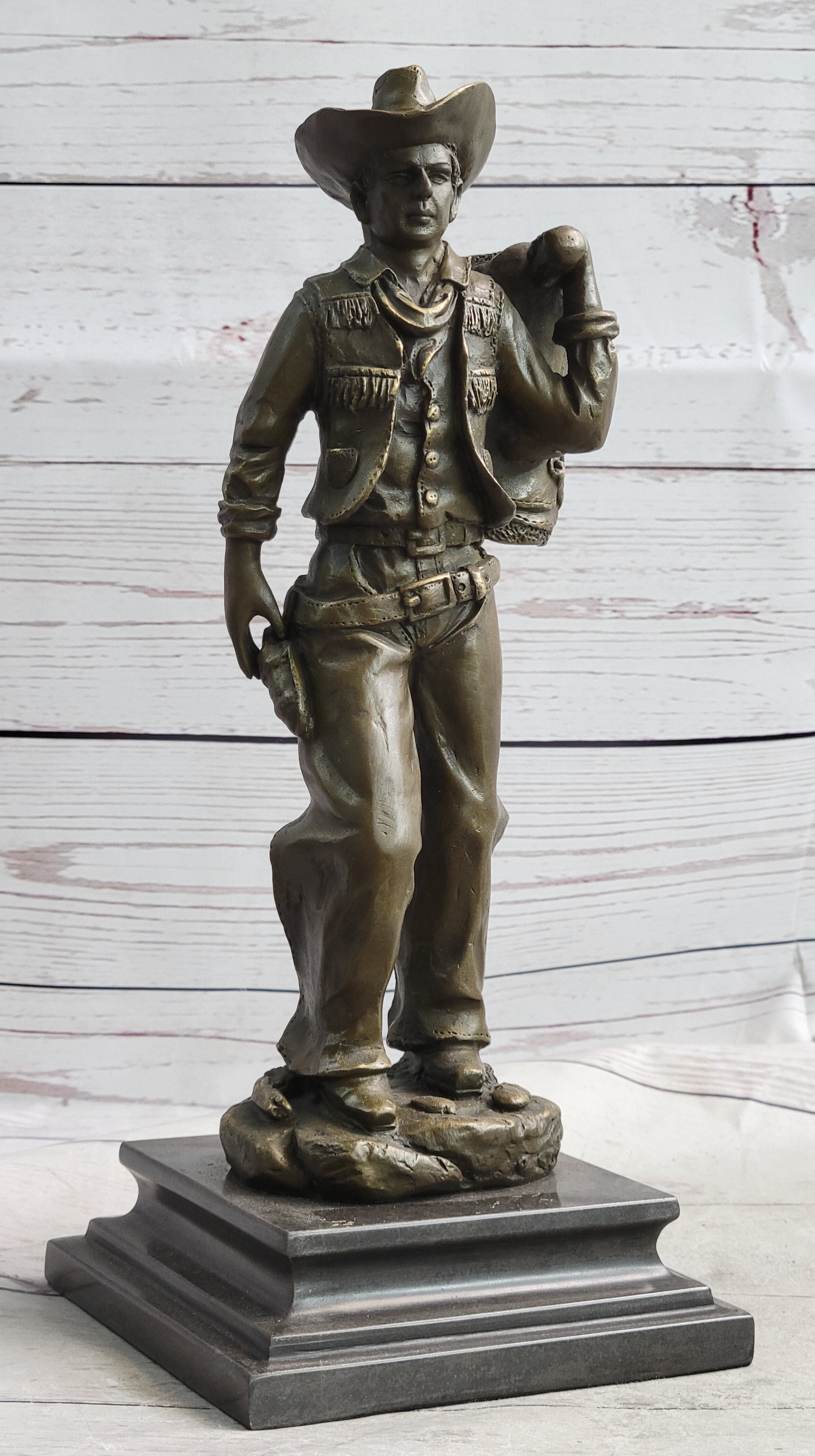 Cowboy in Chaps Carrying Horse Saddle Bronze 12" x 4"