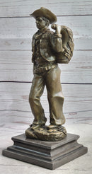 Cowboy in Chaps Carrying Horse Saddle Bronze 12" x 4"