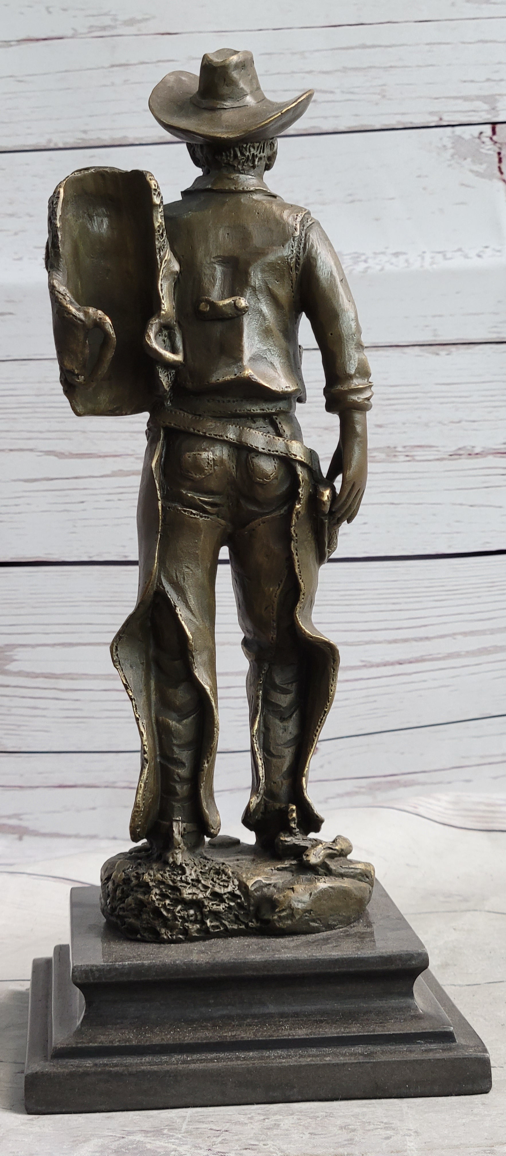 Cowboy in Chaps Carrying Horse Saddle Bronze 12" x 4"