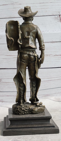 Cowboy in Chaps Carrying Horse Saddle Bronze 12" x 4"