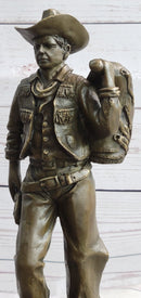 Cowboy in Chaps Carrying Horse Saddle Bronze 12" x 4"