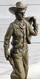 Cowboy in Chaps Carrying Horse Saddle Bronze 12" x 4"