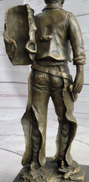 Cowboy in Chaps Carrying Horse Saddle Bronze 12" x 4"