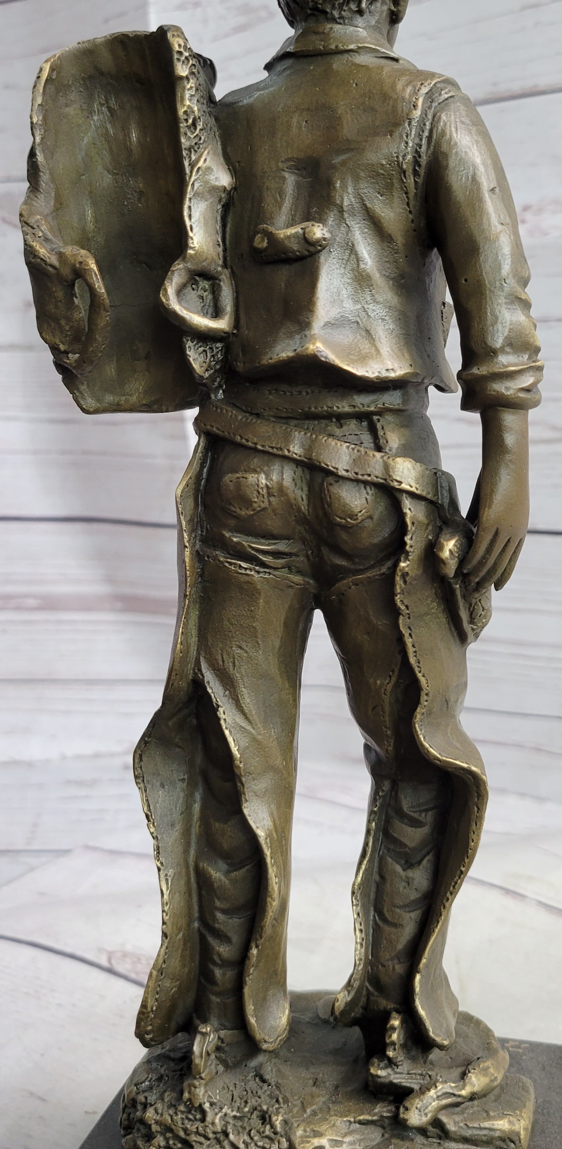 Cowboy in Chaps Carrying Horse Saddle Bronze 12" x 4"