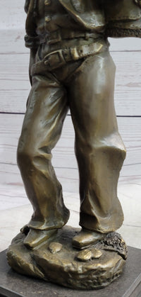 Cowboy in Chaps Carrying Horse Saddle Bronze 12" x 4"