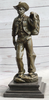 Cowboy in Chaps Carrying Horse Saddle Bronze 12" x 4"