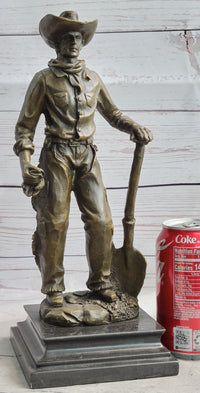 Cowboy in Chaps Holding Shovel Bronze 12" x 5"