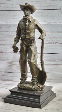 Cowboy in Chaps Holding Shovel Bronze 12" x 5"