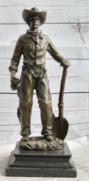 Cowboy in Chaps Holding Shovel Bronze 12" x 5"