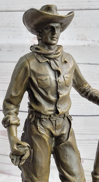 Cowboy in Chaps Holding Shovel Bronze 12" x 5"