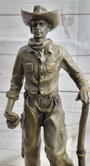 Cowboy in Chaps Holding Shovel Bronze 12" x 5"