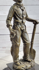 Cowboy in Chaps Holding Shovel Bronze 12" x 5"
