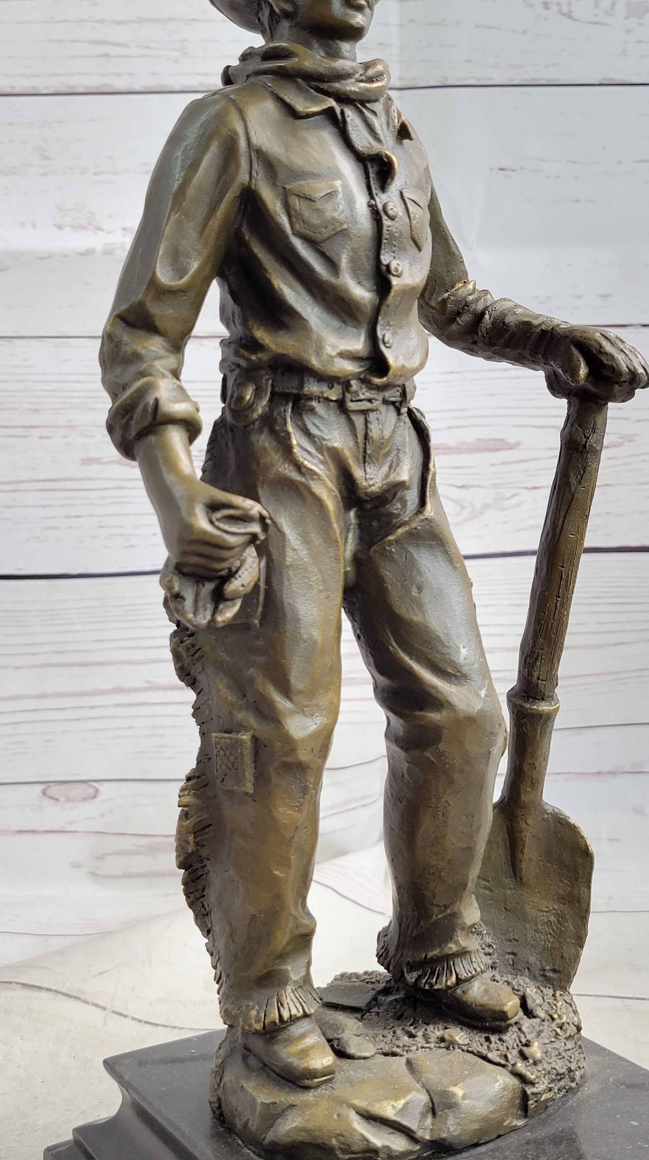 Cowboy in Chaps Holding Shovel Bronze 12" x 5"