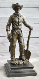Cowboy in Chaps Holding Shovel Bronze 12" x 5"