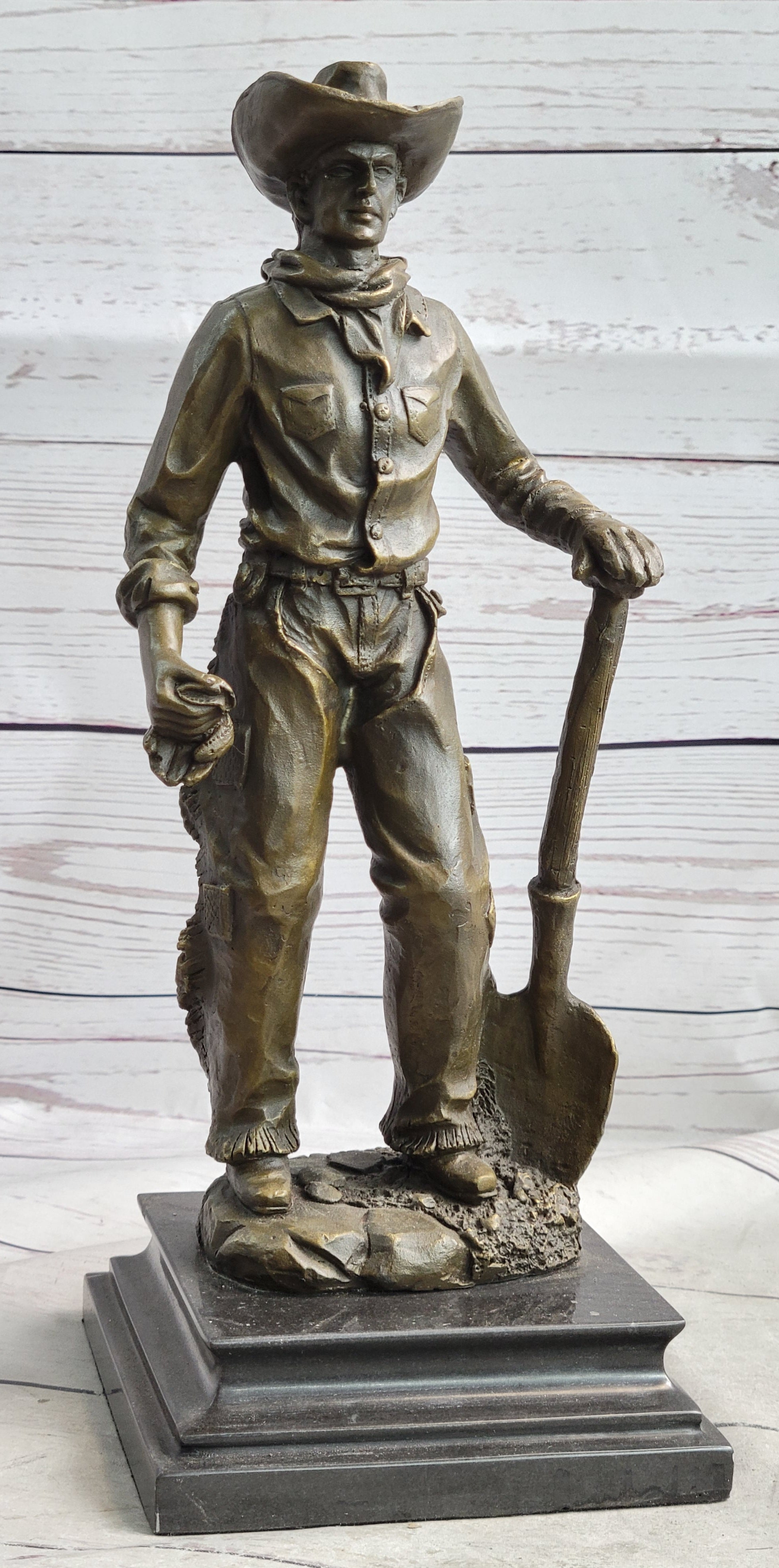 Cowboy in Chaps Holding Shovel Bronze 12" x 5"