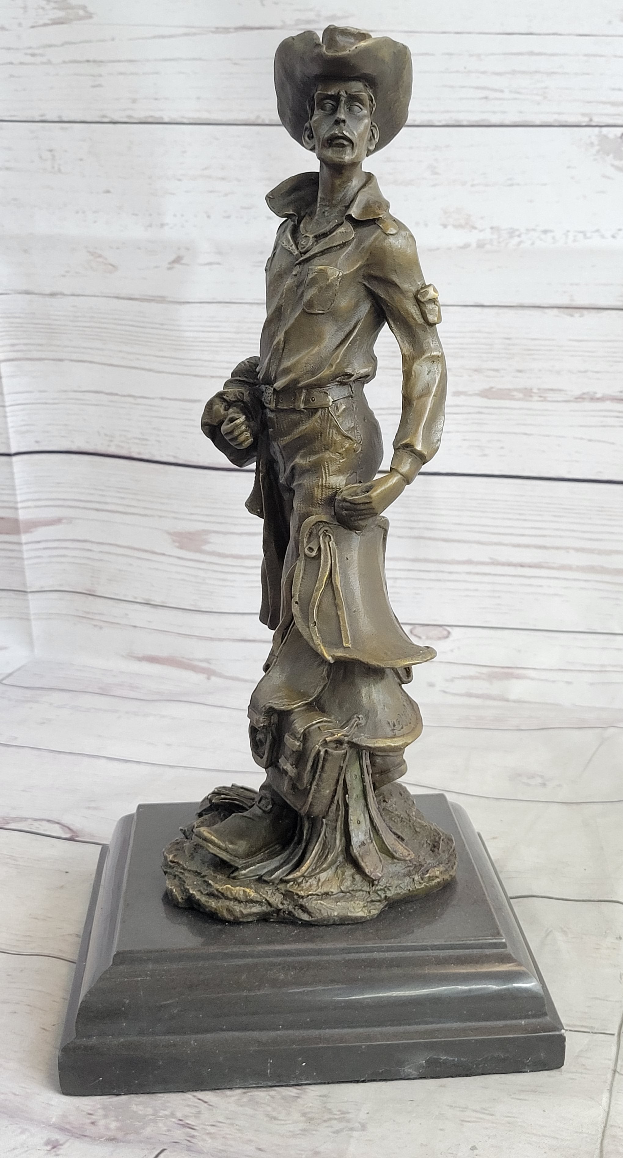 Cowboy Holding Horse Saddle Bronze Sculpture 13" x 6"