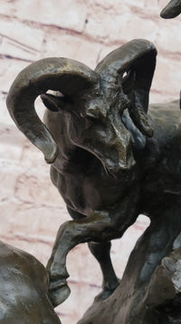 Bronze Sculpture of Rams on Rocky Outcrop – Wildlife Scene