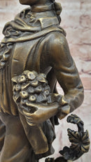 Colonial Era Man Holding Basket of Fruit - Bronze by Milo