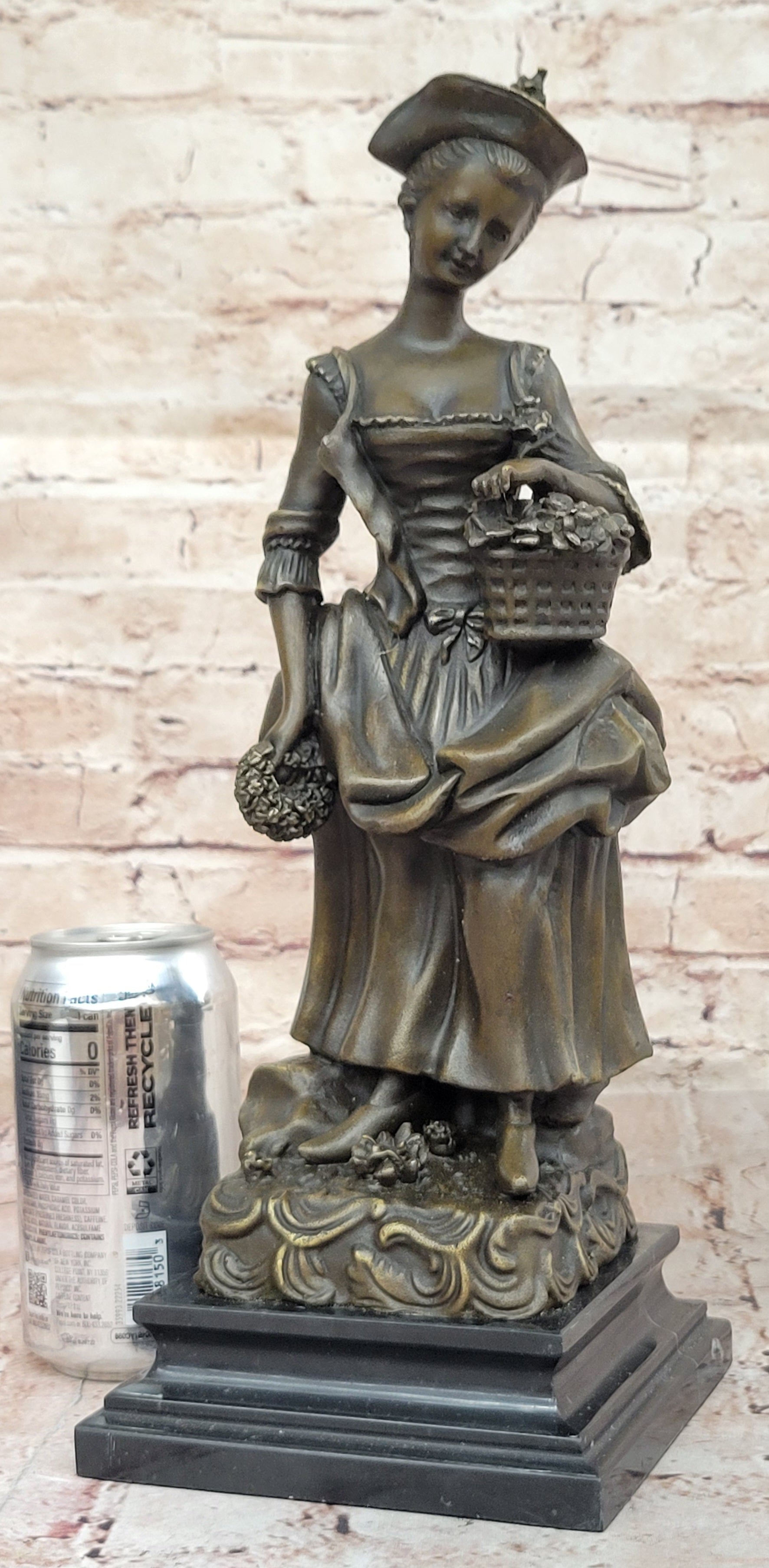 Bronze Sculpture of Woman in Traditional Dress Holding Basket