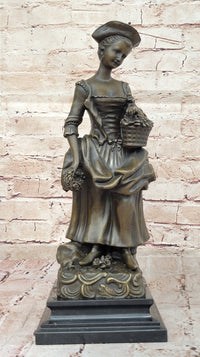 Bronze Sculpture of Woman in Traditional Dress Holding Basket