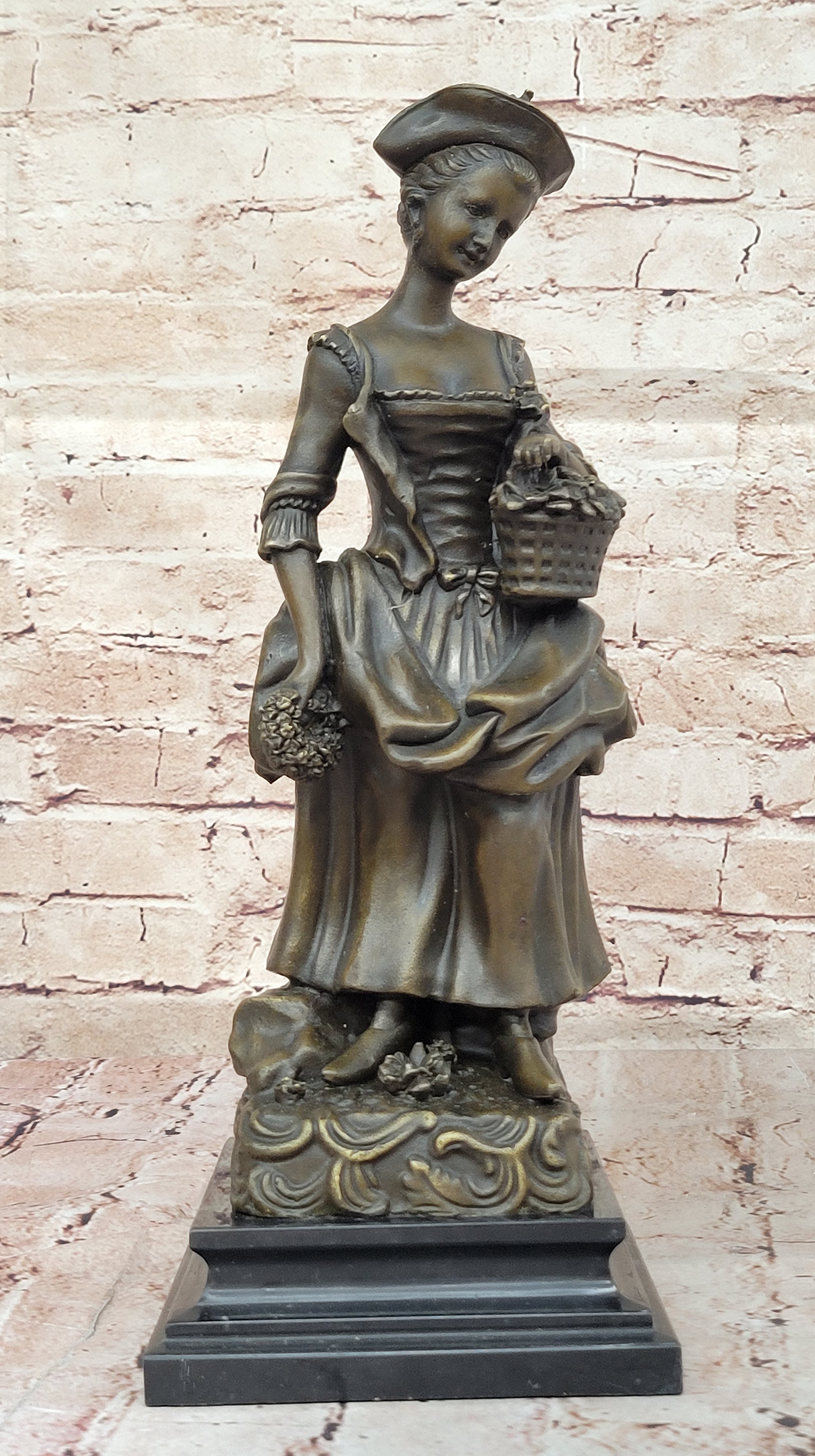 Bronze Sculpture of Woman in Traditional Dress Holding Basket
