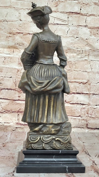Bronze Sculpture of Woman in Traditional Dress Holding Basket