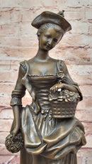 Bronze Sculpture of Woman in Traditional Dress Holding Basket