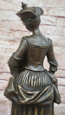 Bronze Sculpture of Woman in Traditional Dress Holding Basket