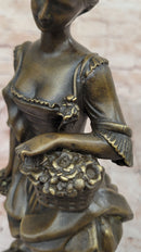 Bronze Sculpture of Woman in Traditional Dress Holding Basket
