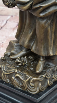 Bronze Sculpture of Woman in Traditional Dress Holding Basket