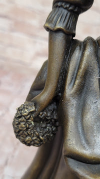Bronze Sculpture of Woman in Traditional Dress Holding Basket