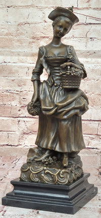Bronze Sculpture of Woman in Traditional Dress Holding Basket